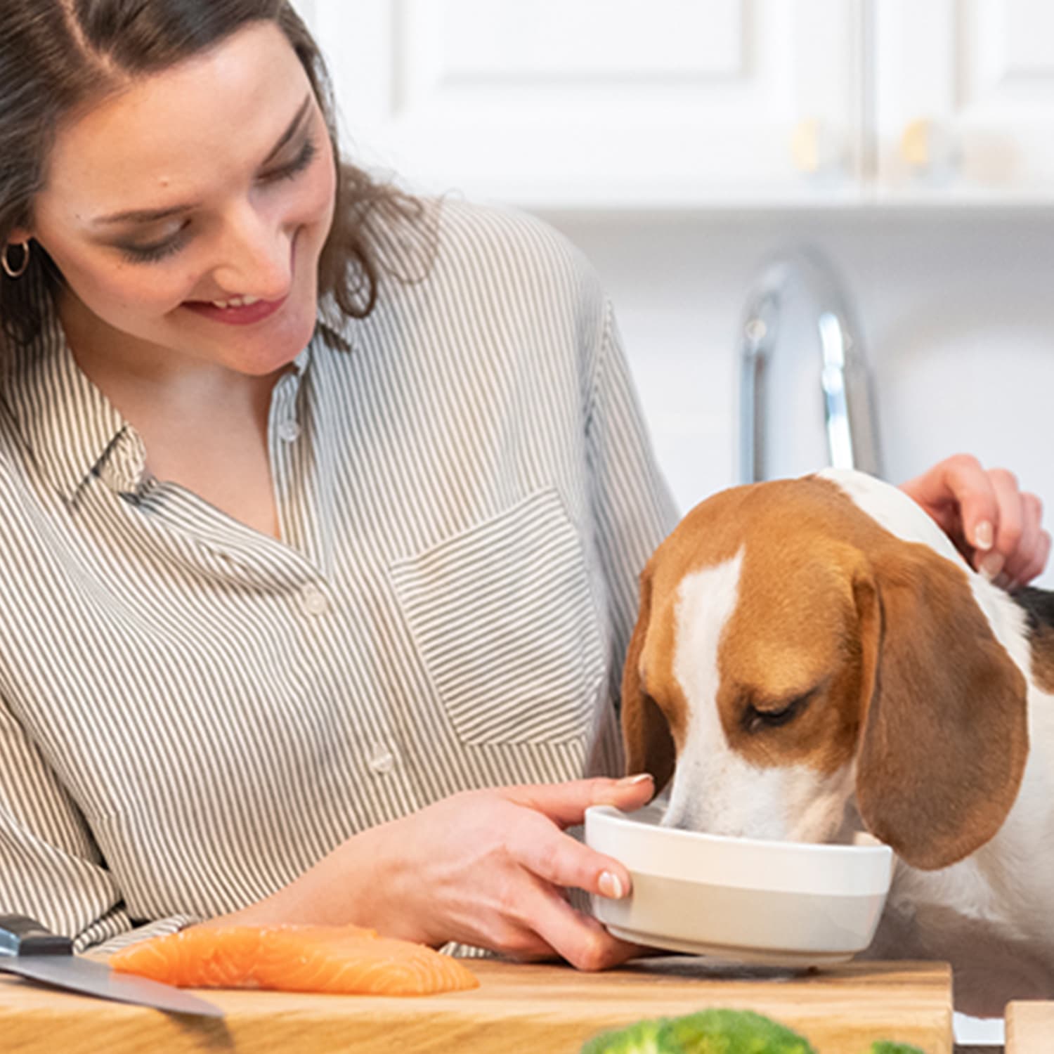 A woman holding a dog