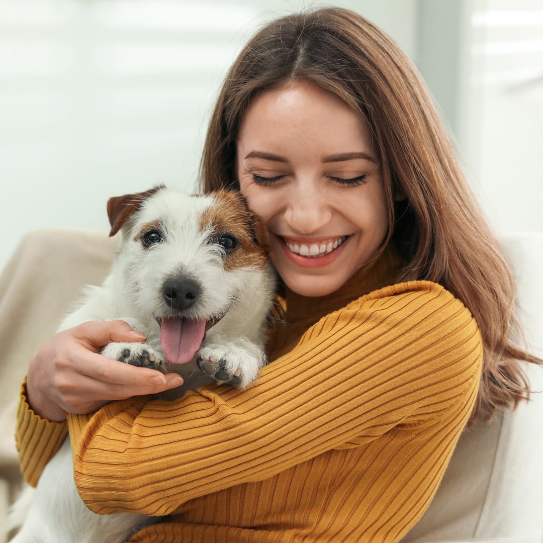 A woman holding a dog