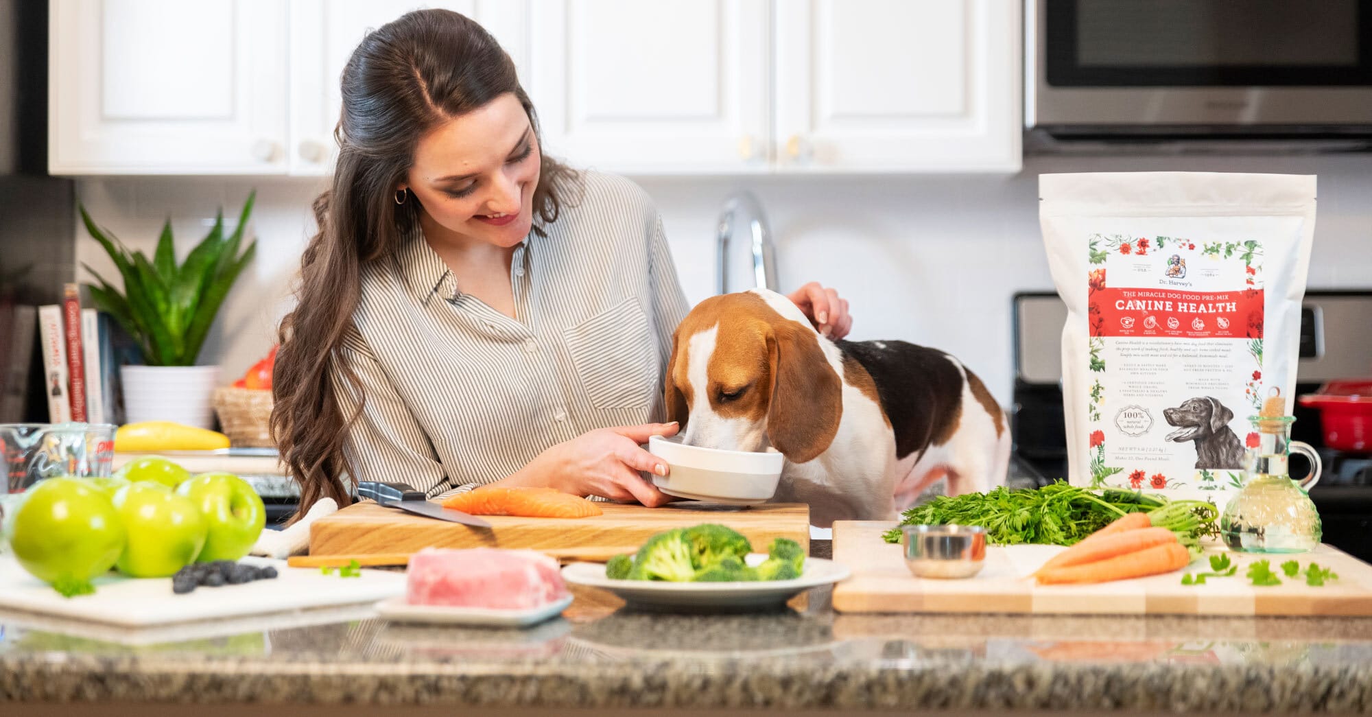A woman and a dog eating food