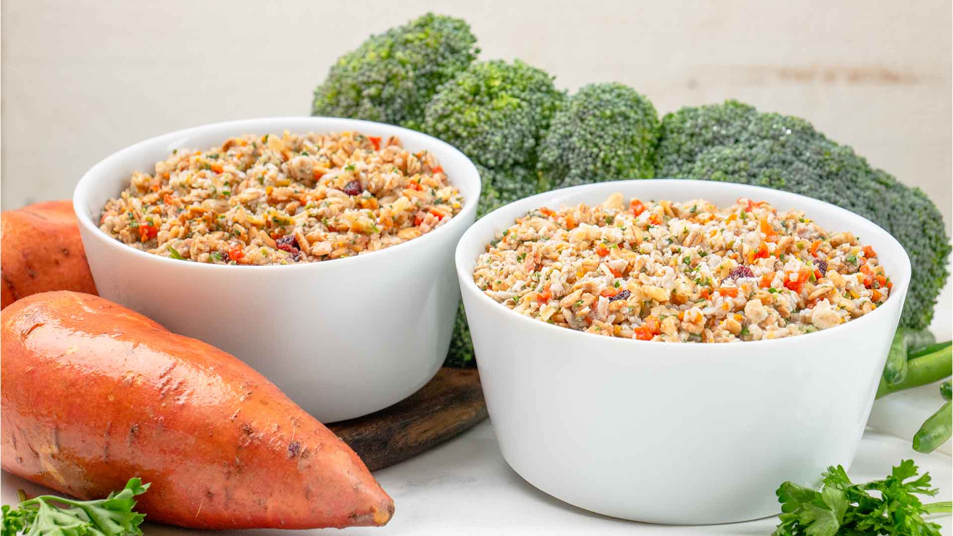 A bowl of rice and vegetables next to a bowl of rice