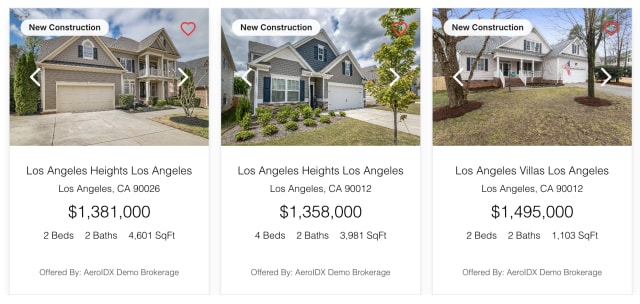 Three Classic property cards side by side. Each has a wide photo with a New Construction pill and a favourite heart. The text underneath is centred: community, city, price, then beds, baths and square feet on one line.