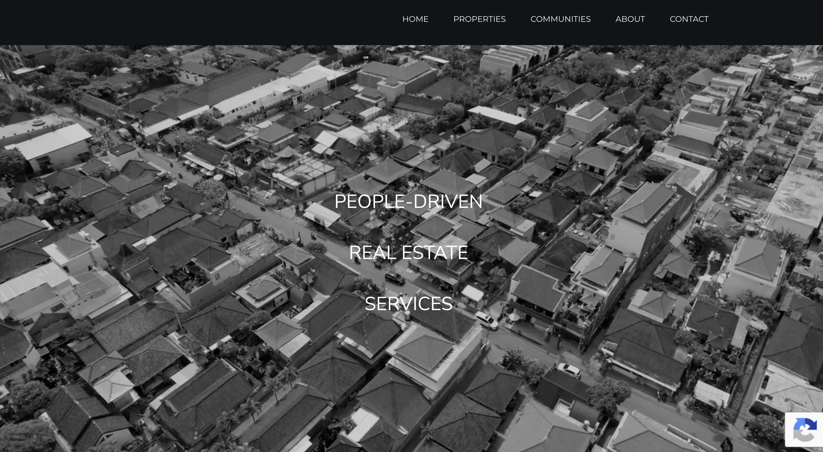 Signature theme homepage: a black-and-white aerial photo of a neighborhood with the words People-Driven Real Estate Services centered over it