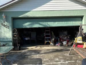 Green garage door exterior with customer