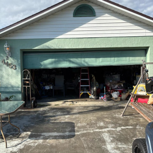Green garage door exterior with customer