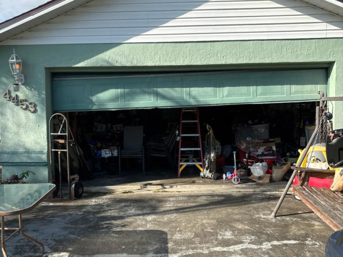 Green garage door exterior with customer