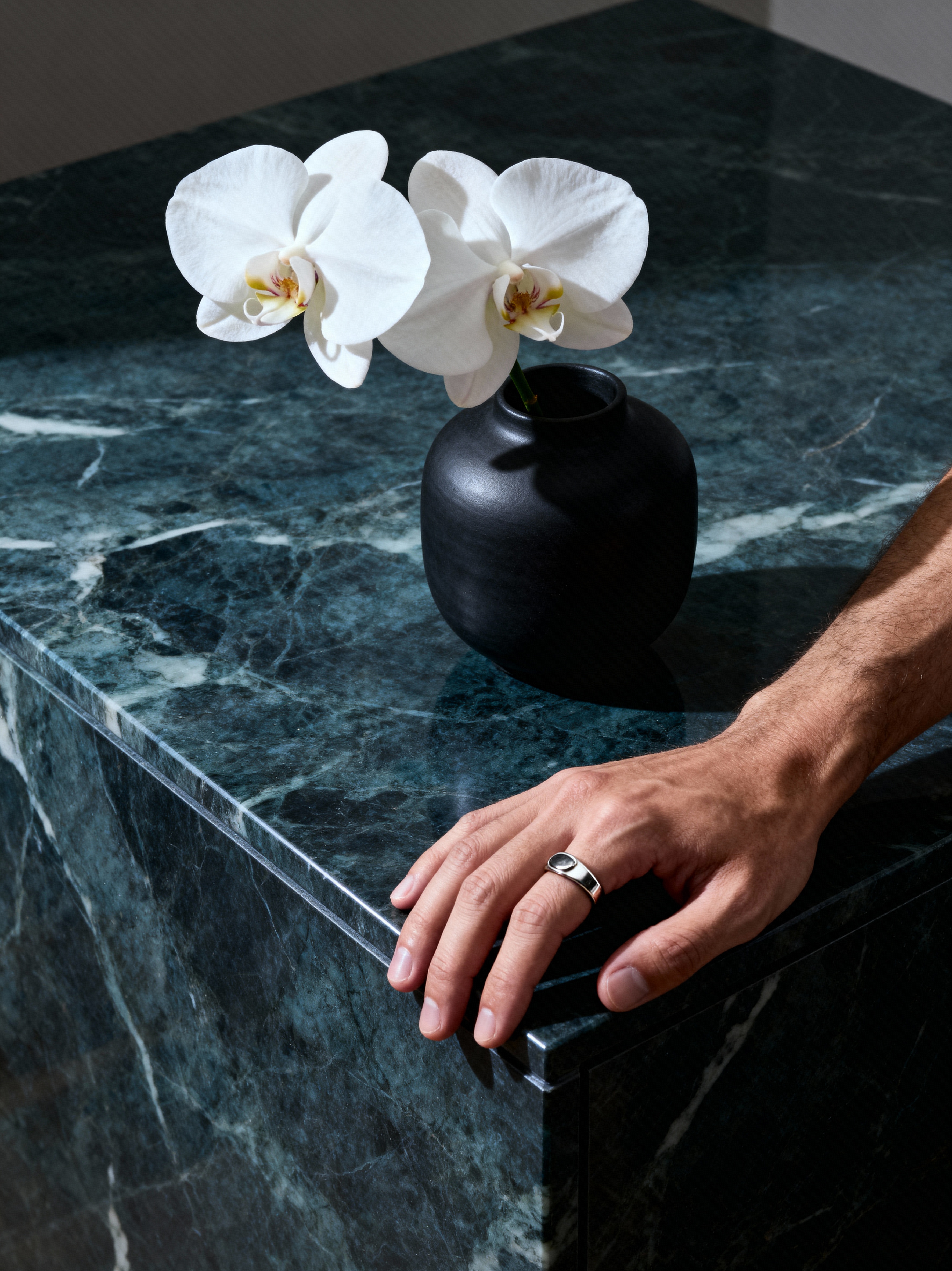 A single, elegant white orchid in a minimalist vase.