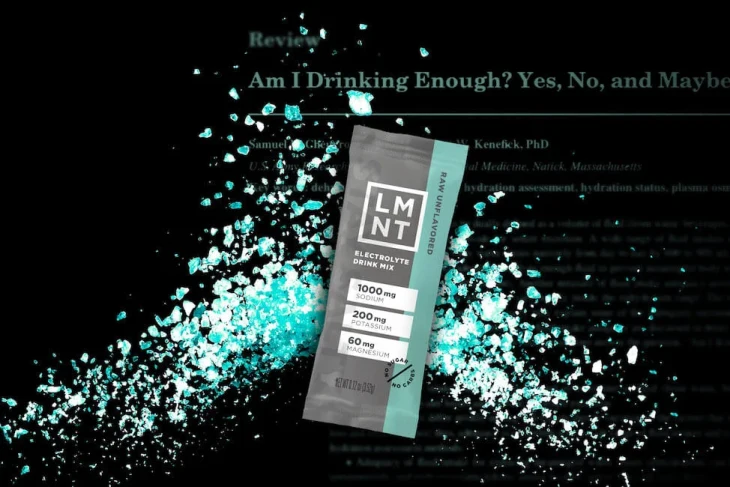 Raw unflavoredLMNT electrolyte stick, exploding with blue salts. Blog text in the background.