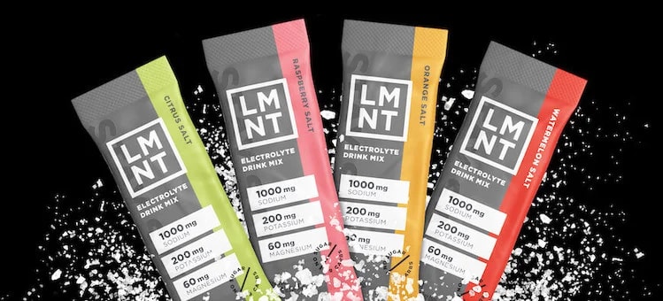 Four LMNT electrolyte packets arranged in an arc, each with different colored accents showing various flavors