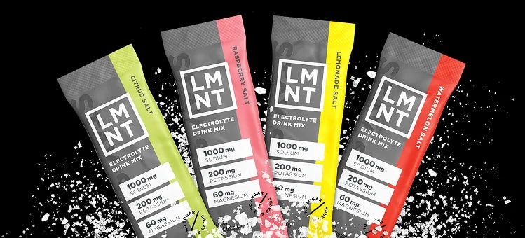 Four LMNT electrolyte packets arranged in an arc, each with different colored accents showing various flavors