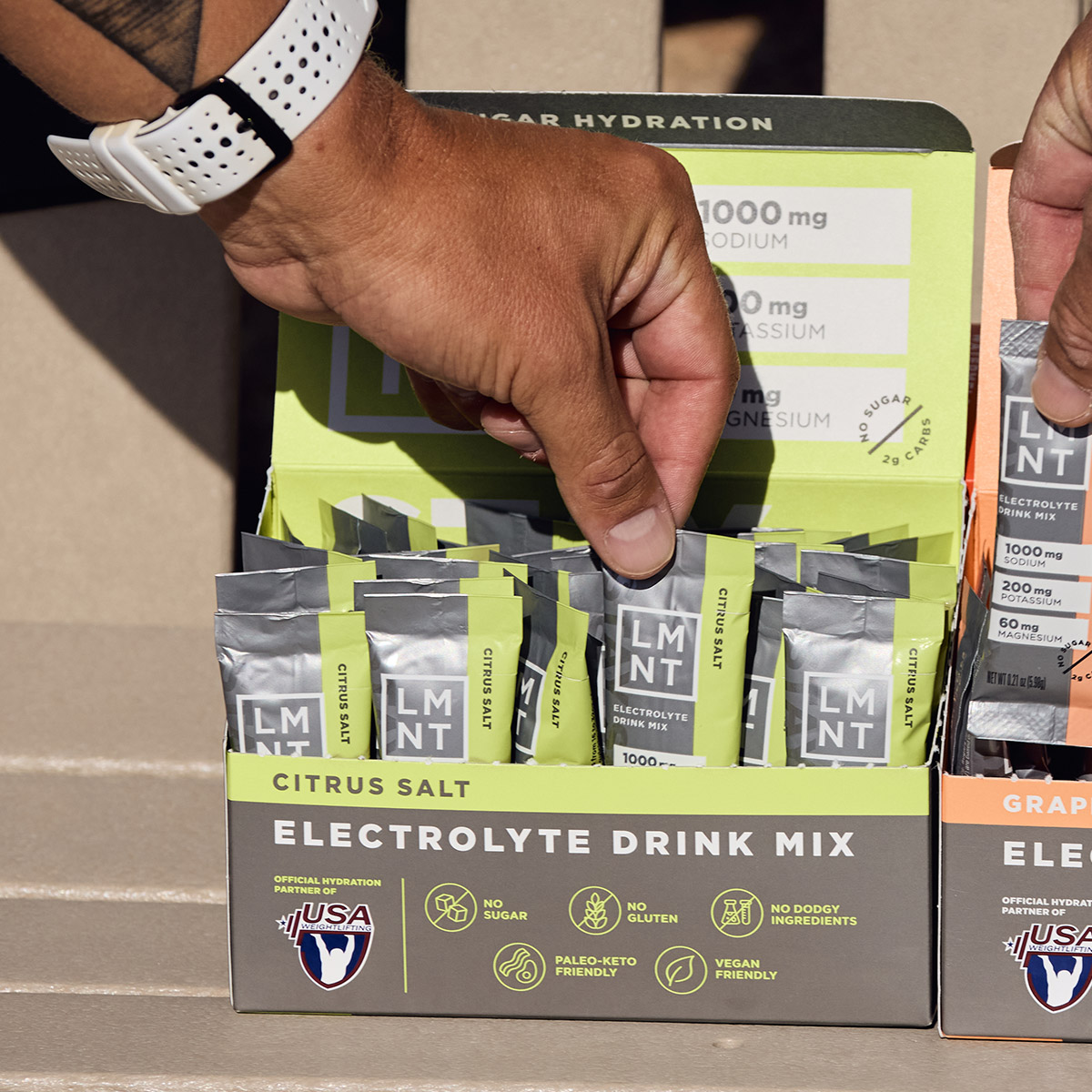 Black Cherry Lime sparkling electrolyte drink can on a gym bench with athlete nearby.