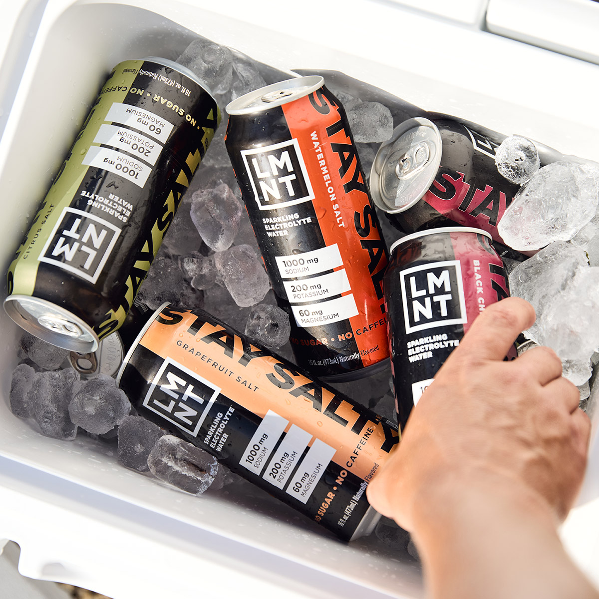 Black Cherry Lime sparkling electrolyte drink can on a gym bench with athlete nearby.