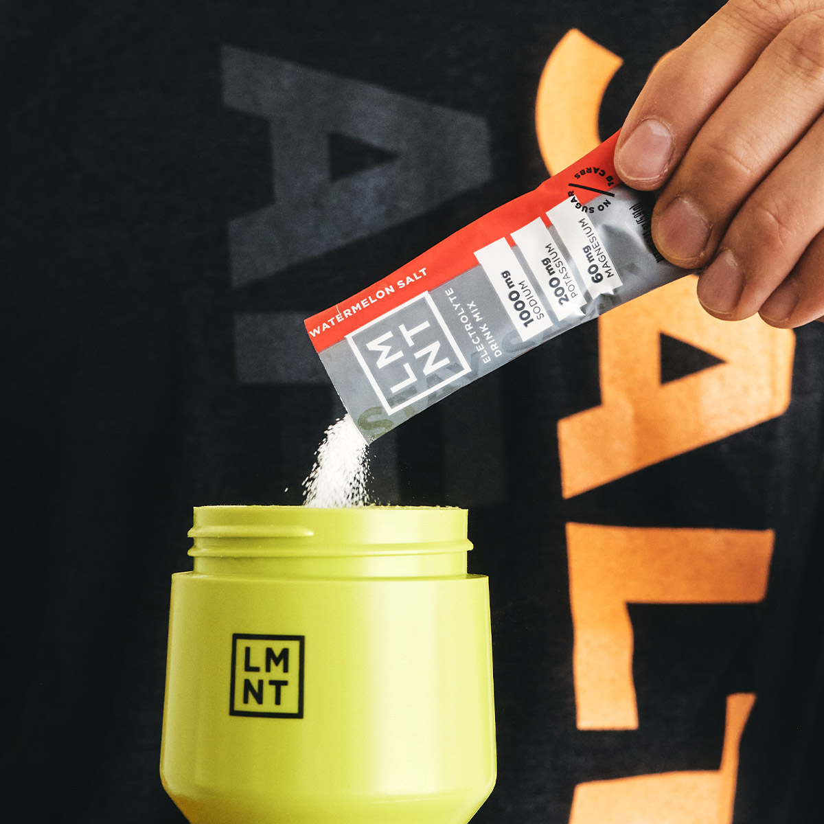 Hand selecting a LMNT electrolyte packet from a retail box containing only Grapefruit packets