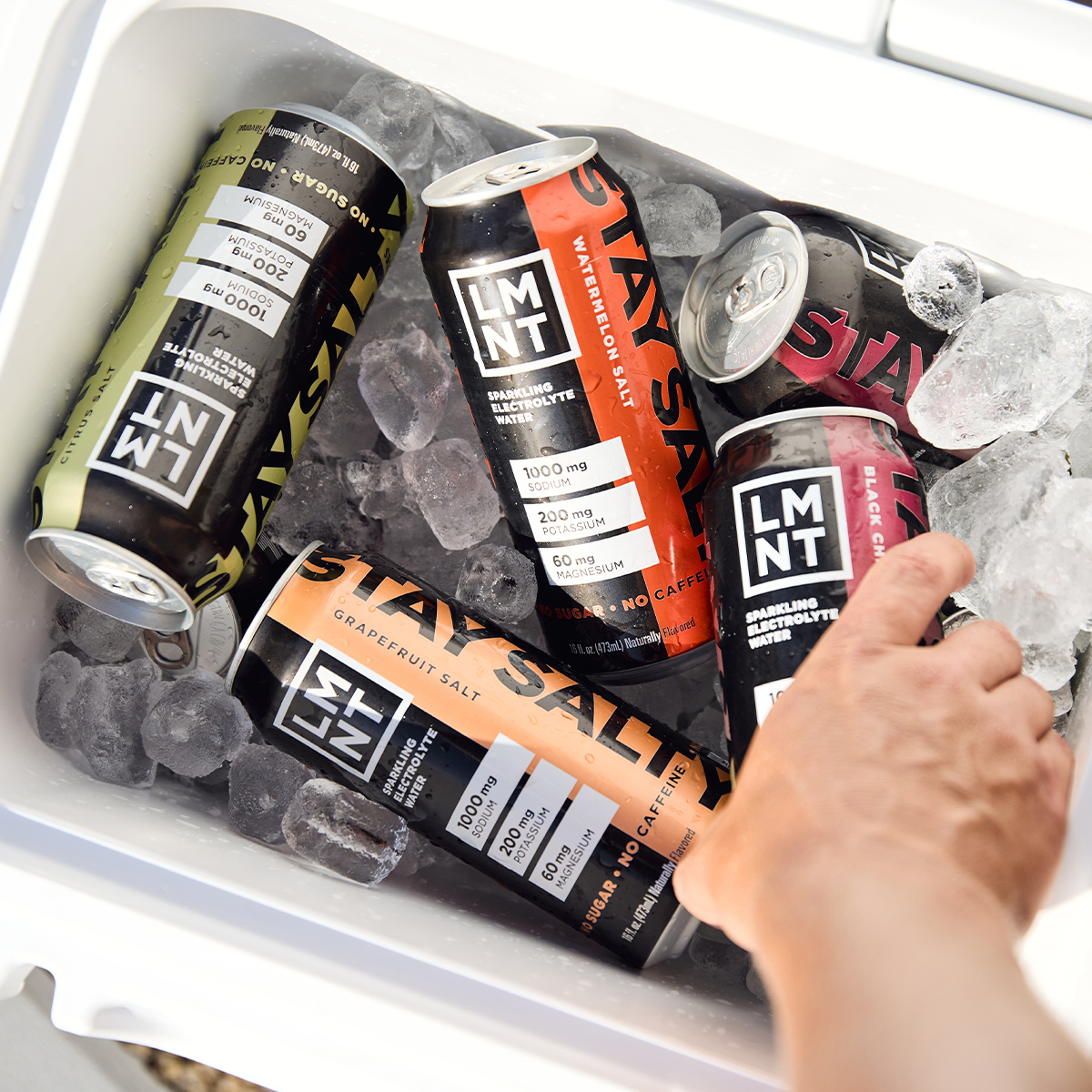 Black Cherry Lime sparkling electrolyte drink can on a gym bench with athlete nearby.