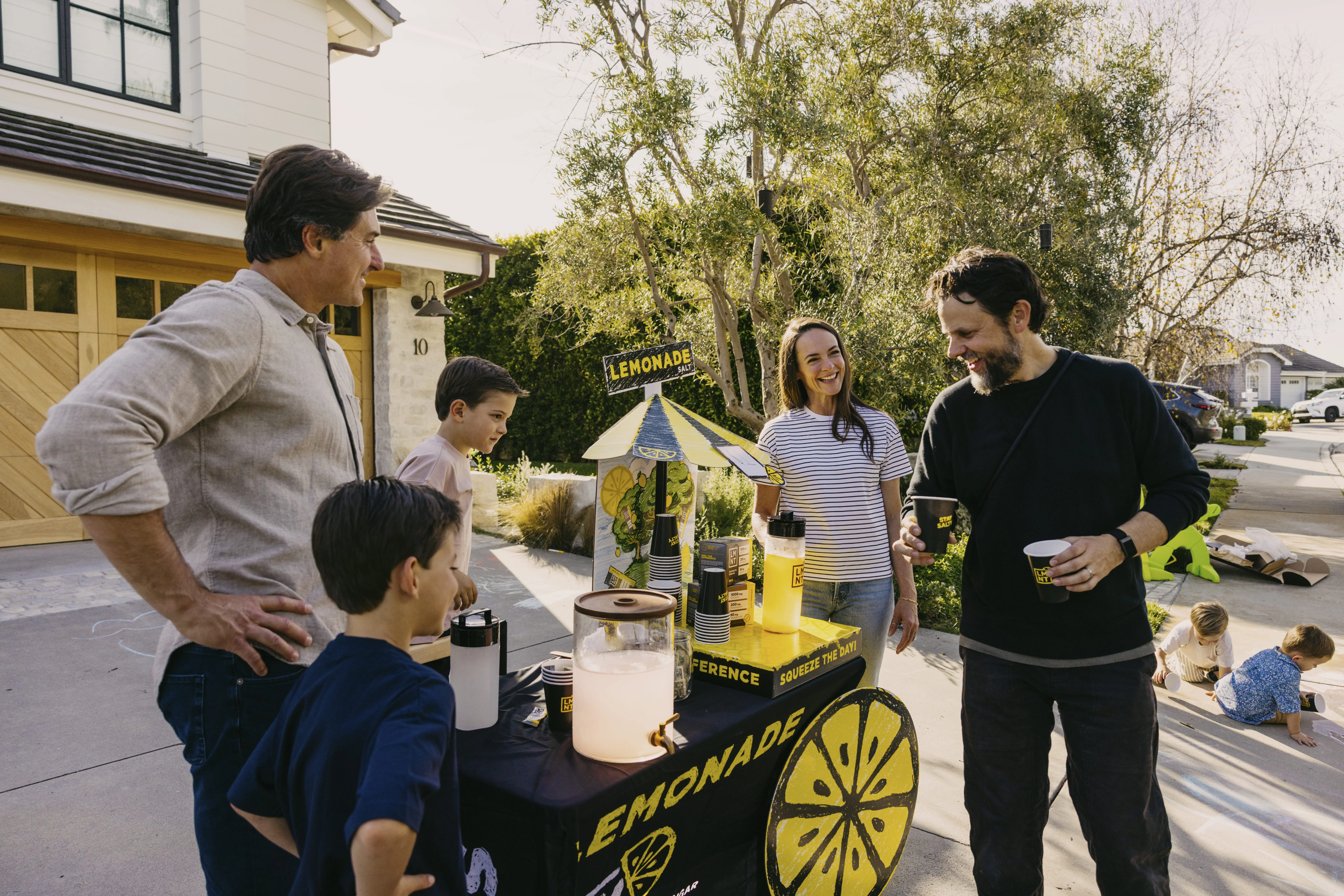 Kelly LeVeque with her family around an LMNT Lemonade Stand