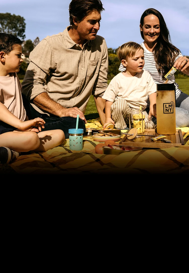 A family enjoying LMNT Lemonade Iced Tea together at a picnic