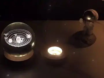 Solar System crystal ball lighting up on base, showing intricate laser engraving detail