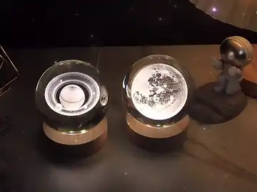 Hand placing Moon crystal ball onto LED base, demonstrating ease of use