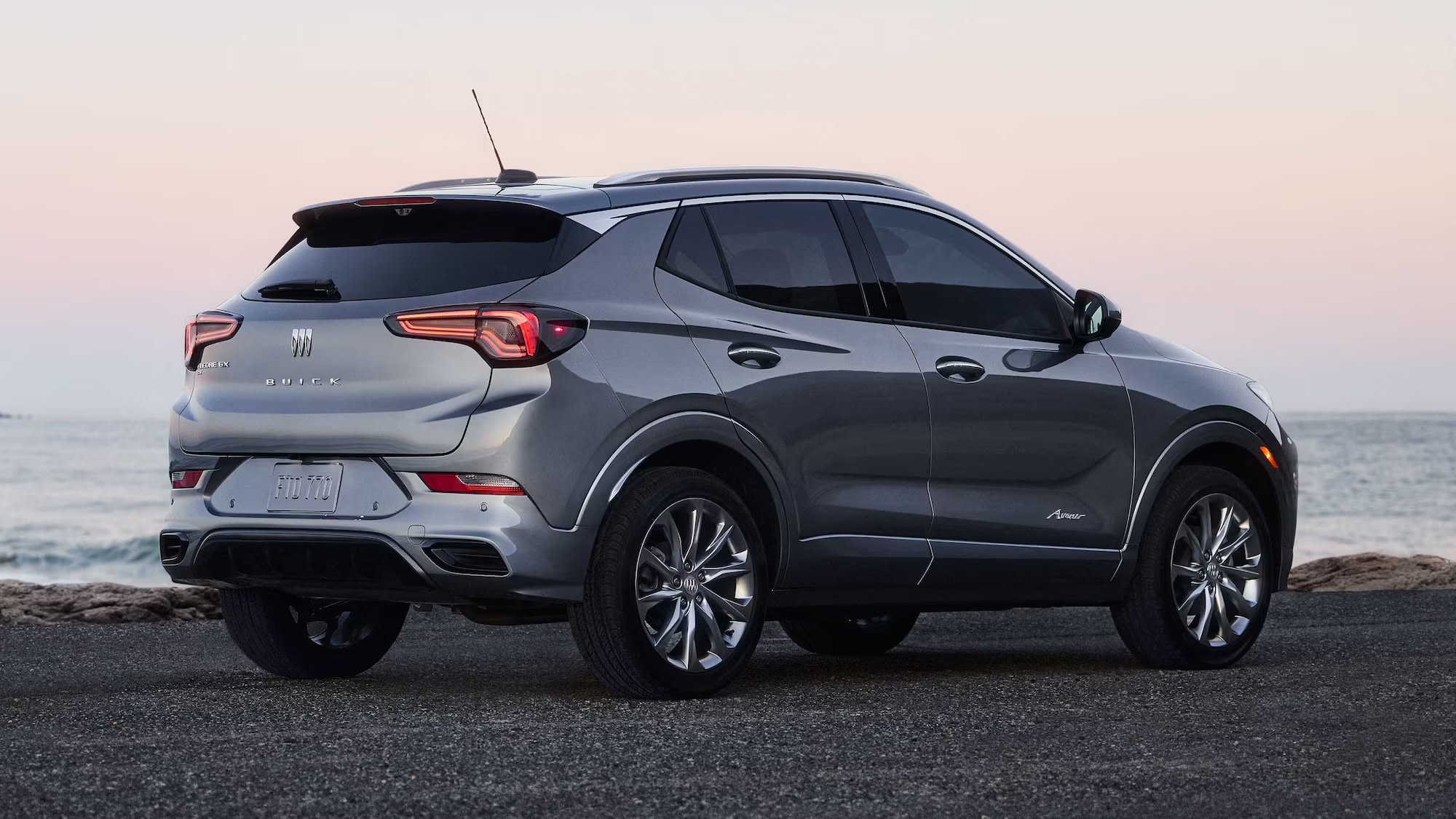 2026 Buick Encore GX Preferred driving on a winding road, showcasing agile performance.