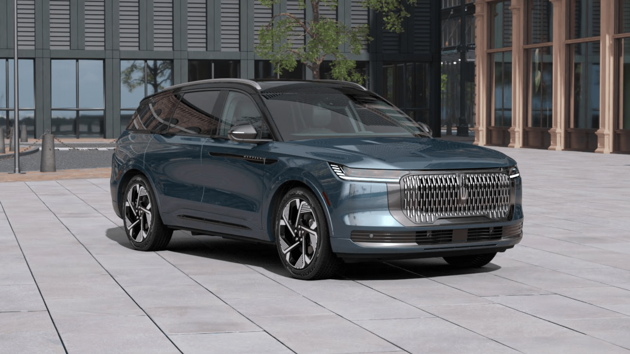 A sleek blue electric SUV parked on a light-colored tiled plaza in front of modern glass and stone buildings.