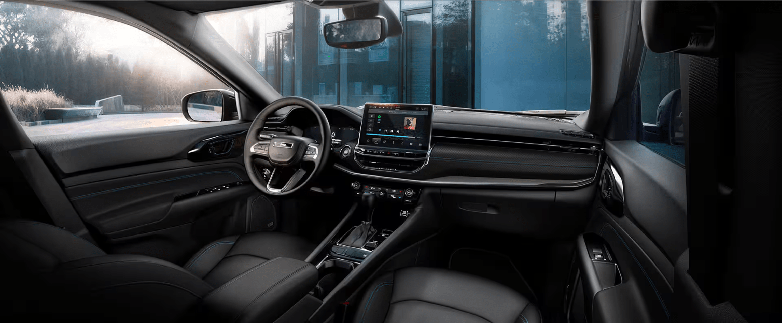 A modern black car interior with a digital dashboard and leather seats is set against a background of a contemporary glass building.