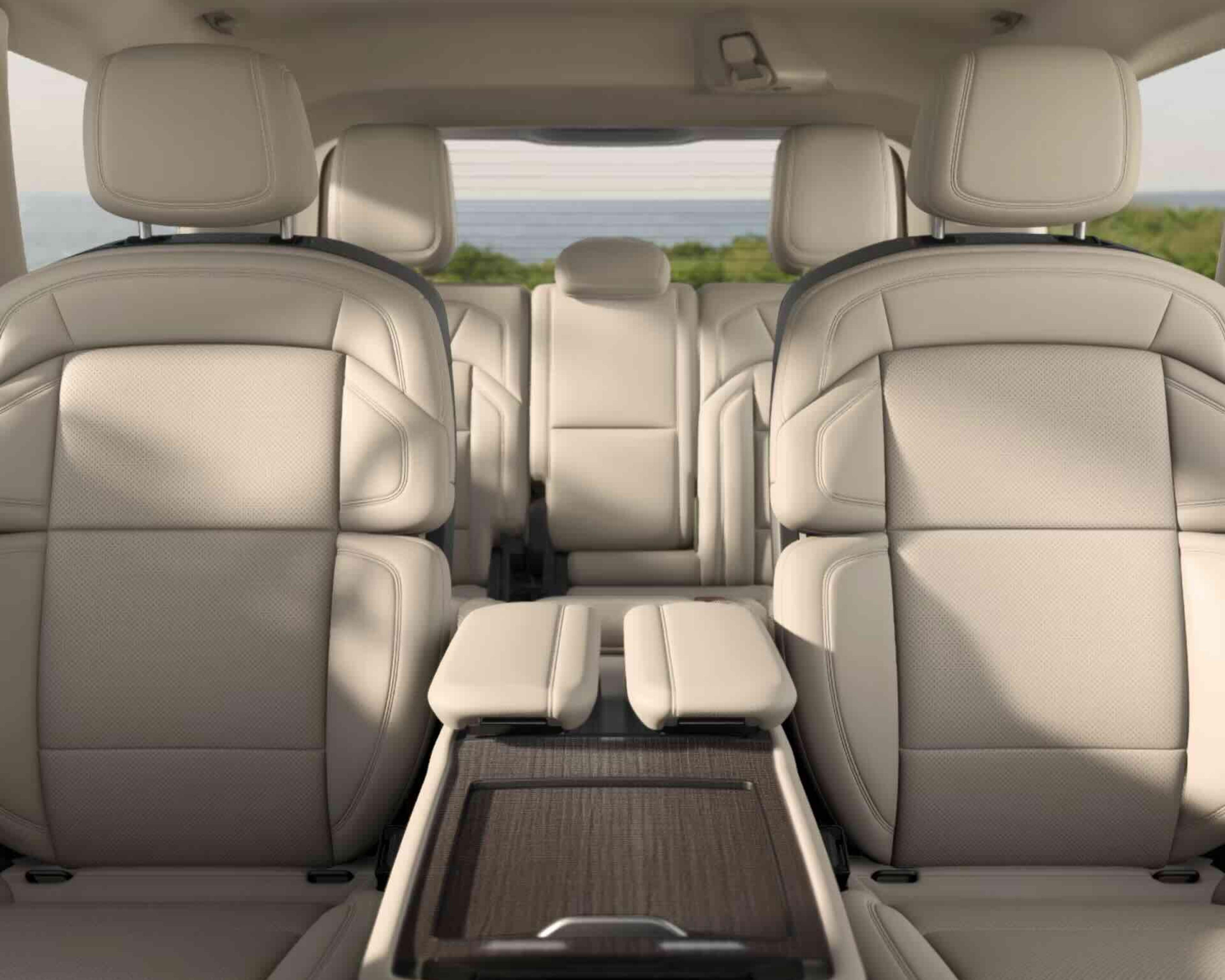 Cream leather seats with ocean view through rear window.
