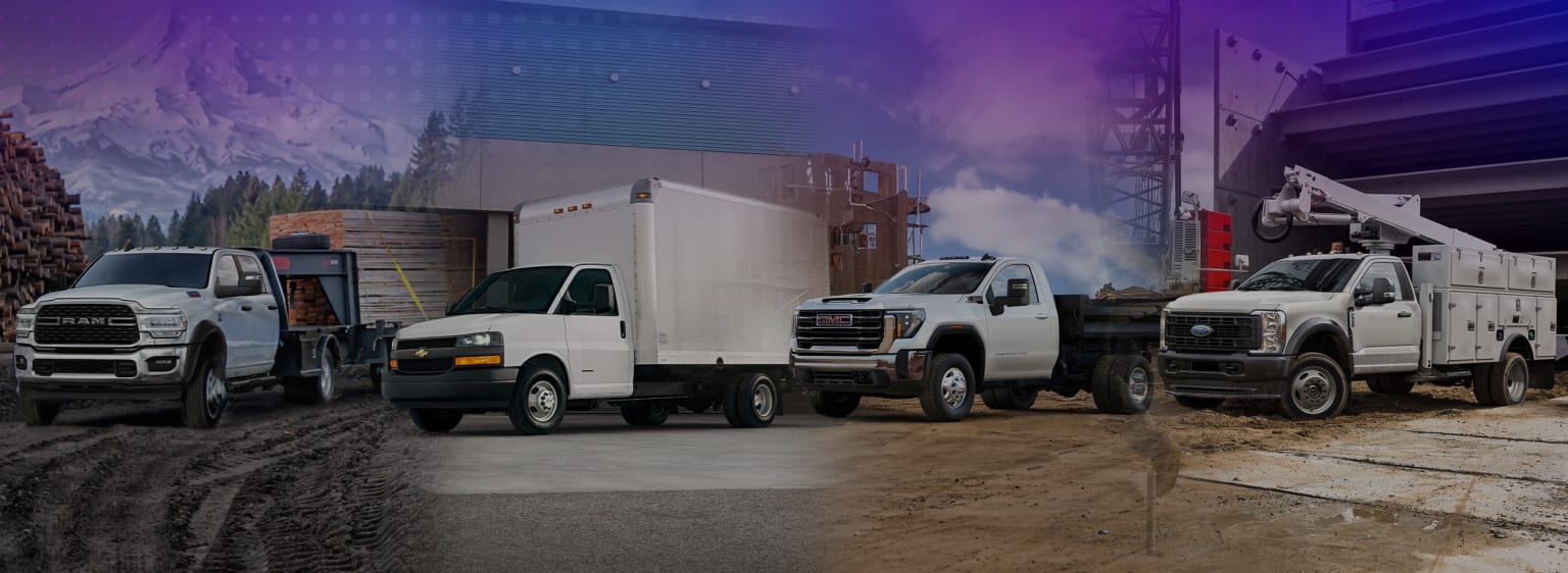 three trucks are parked in front of a building and one is white and the other is black and white