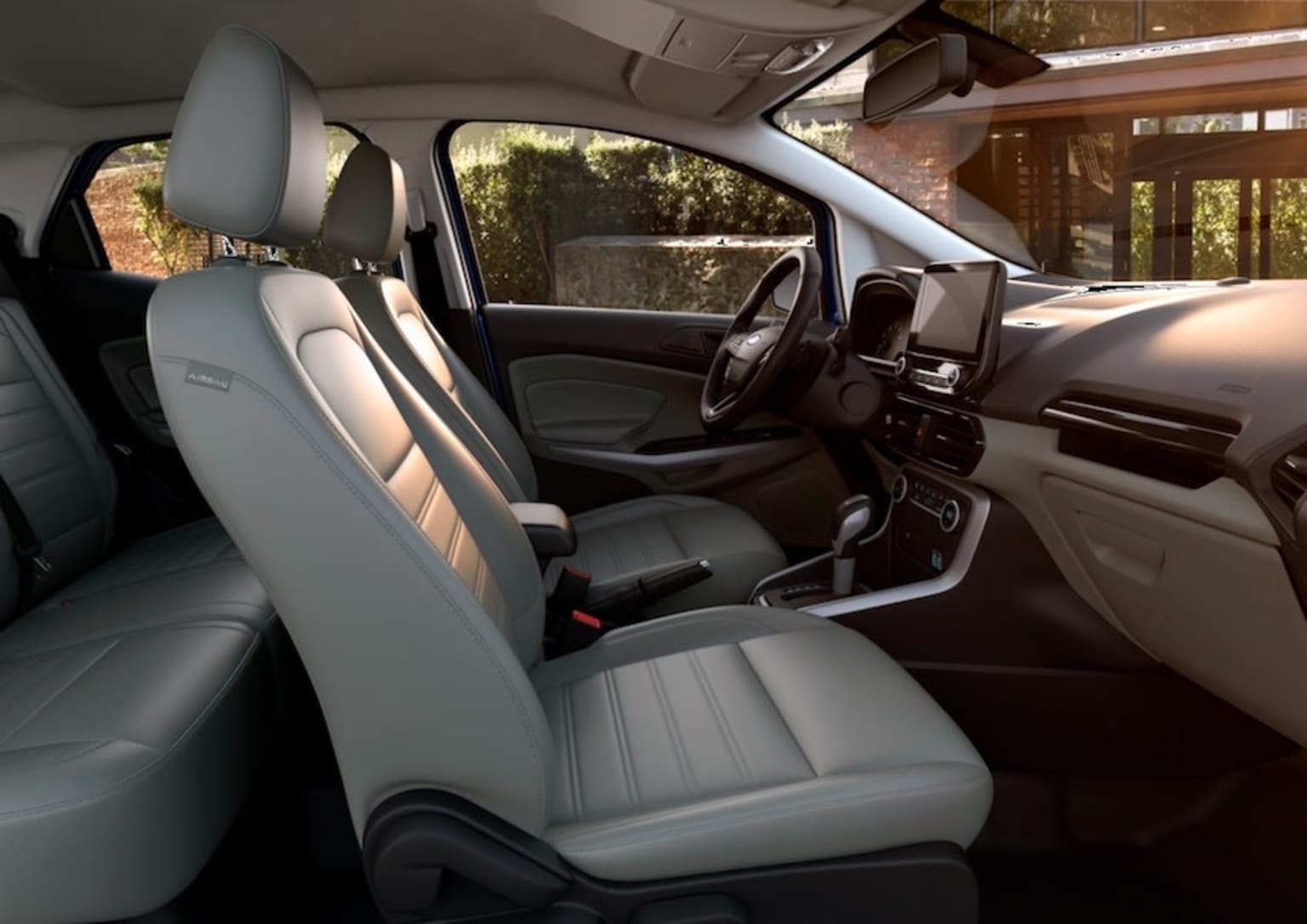 the interior of a car with a grey leather seat and a black leather steering wheel and a black dashboard