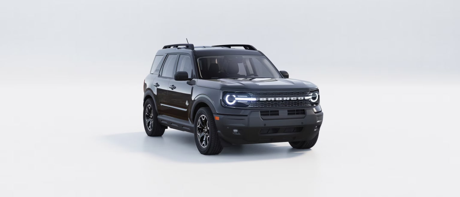 A rugged, black off-road vehicle with a distinctive grille and headlight design stands against a plain, light-colored background.