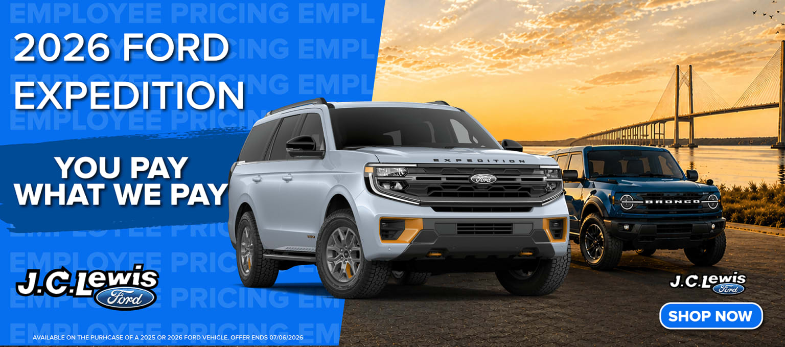 Image of a white SUV displayed in front of a colorful sunset sky.