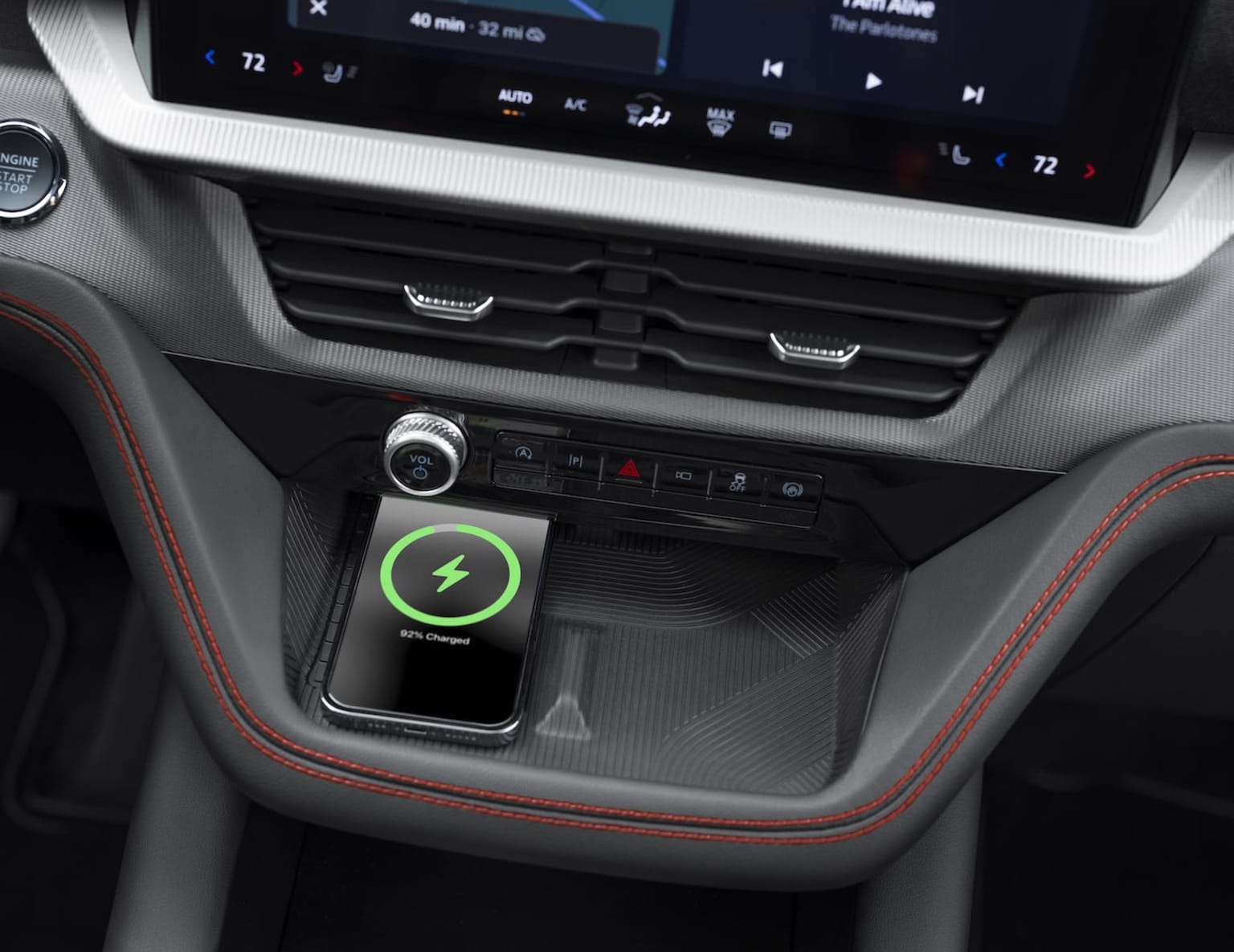 The image depicts a 2025 Ford Explorer center console with a wireless charging pad for a smartphone, surrounded by various controls and displays.