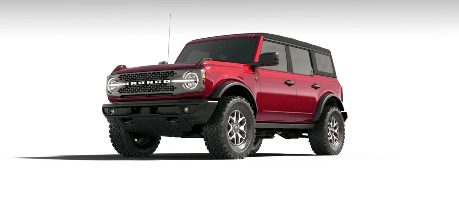 Off-road vehicle with large tires and boxy, angular design in bright red color.