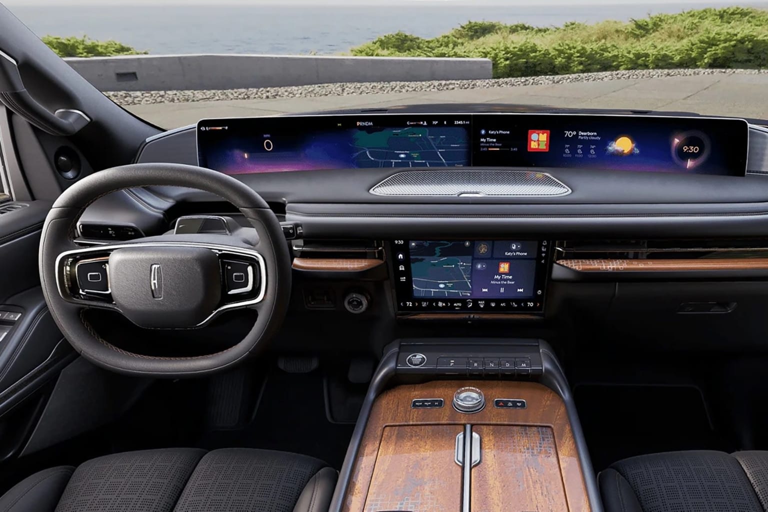 The image shows the interior of a modern, high-tech vehicle with a large digital display panel in the center console, a steering wheel, and a wooden-accented dashboard.