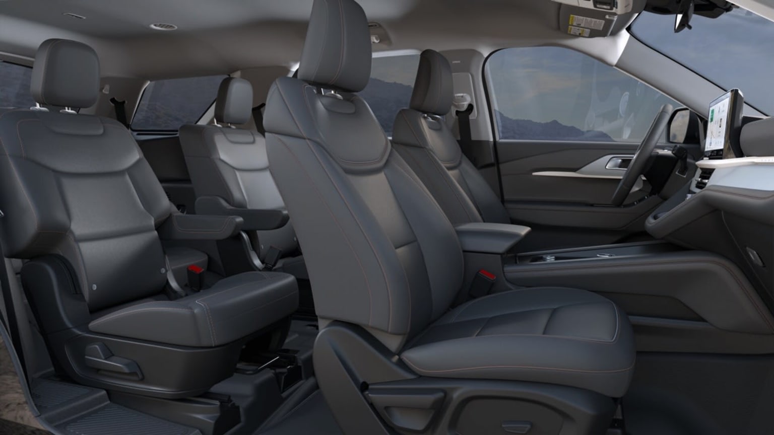 The image depicts the interior of a vehicle with gray upholstered seats and various controls and features visible in the background.