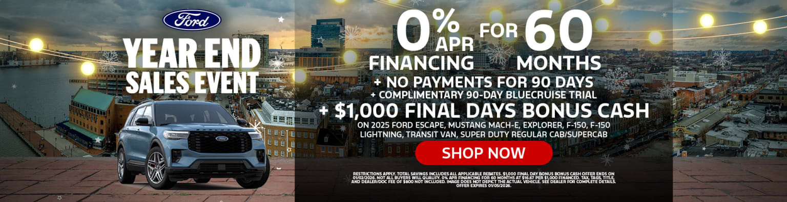 The image displays a Ford dealership advertisement featuring a sunset skyline in the background, with various Ford vehicles prominently displayed in the foreground along with details about a financing promotion.