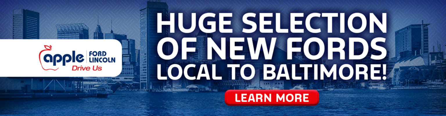 A white banner with a dealership logo is in the foreground, with a city skyline and water in the background.