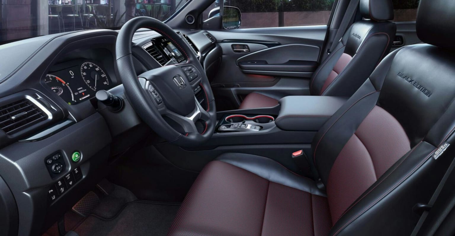 The foreground shows the driver's seat and dashboard of a car, while the background displays the passenger seat and interior door panel.