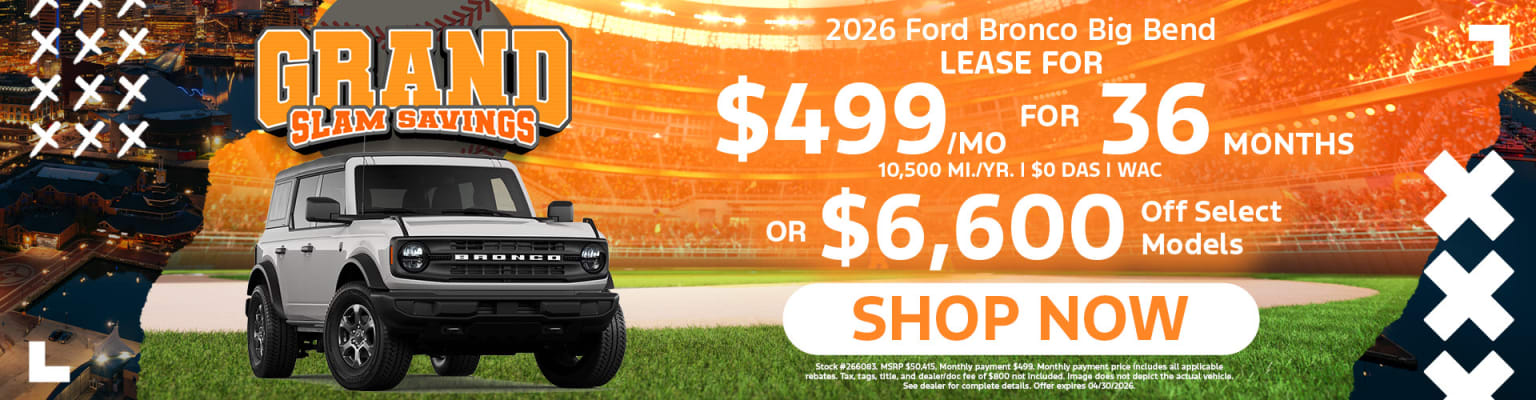 The image shows a SUV vehicle prominently featured in the foreground, with a promotional advertisement in the background showcasing lease options.