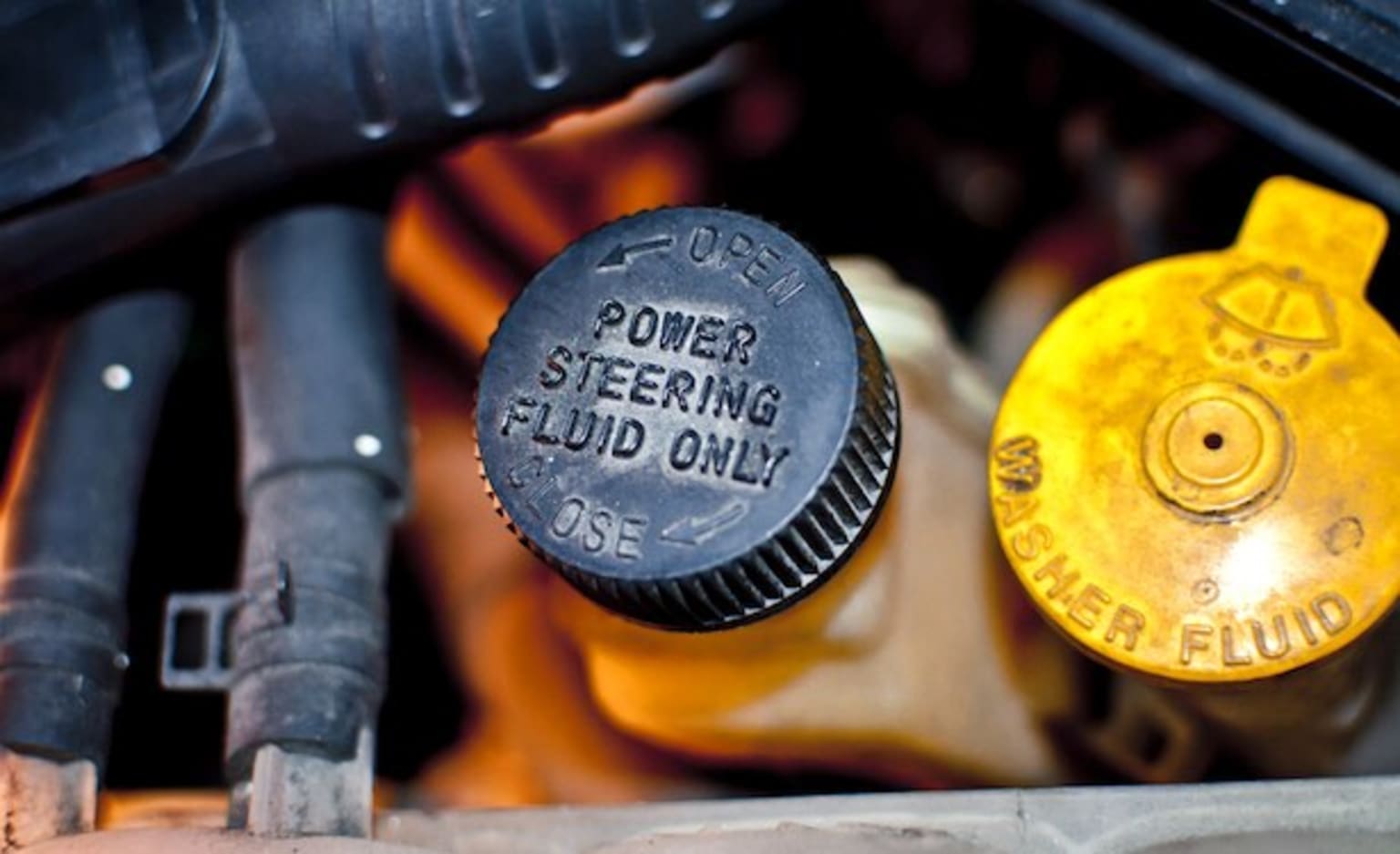 a close up of a car's engine with a power steering fluid on the top of the engine