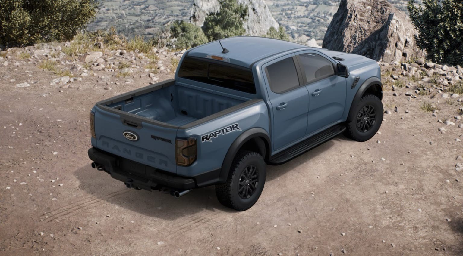 A rugged, off-road pickup truck parked on a dirt path surrounded by rocky, mountainous terrain.