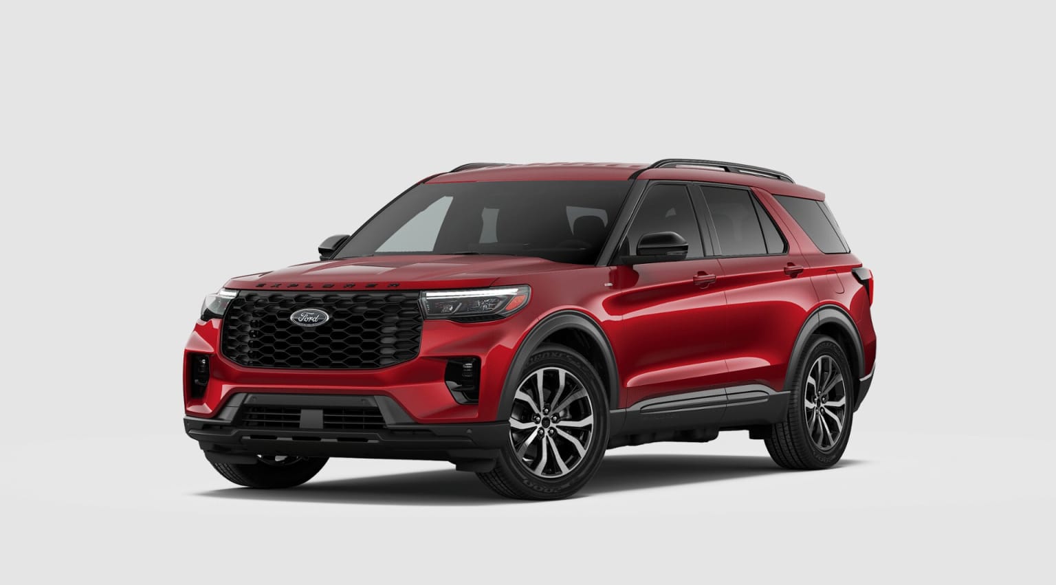 A large, red sport utility vehicle with a bold, angular design and prominent grille is the focal point of the image, set against a plain white background.