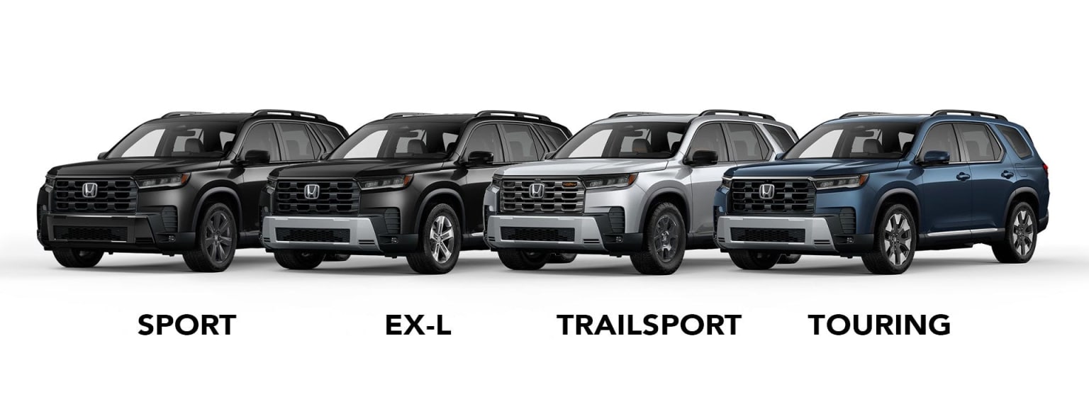 Four SUVs with different trims are lined up against a white background.