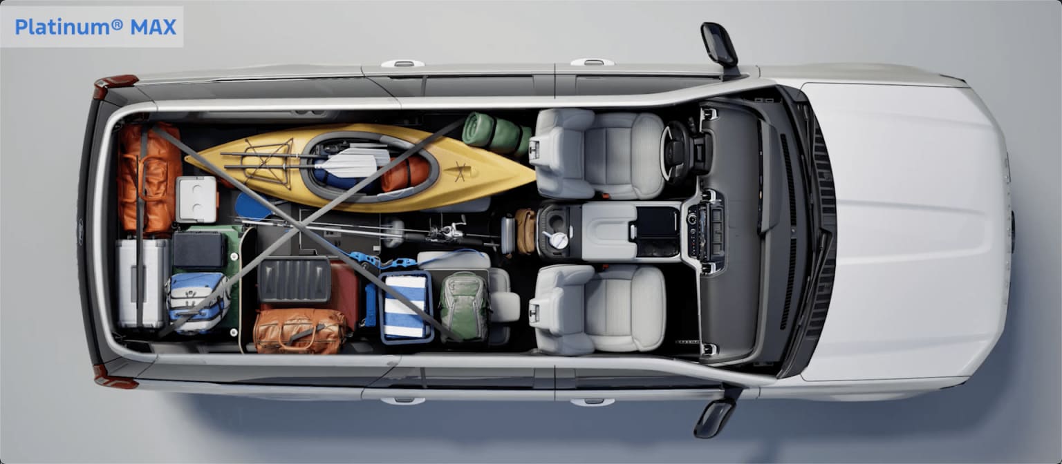 Interior of a van or cargo vehicle filled with luggage, tools, and miscellaneous objects.