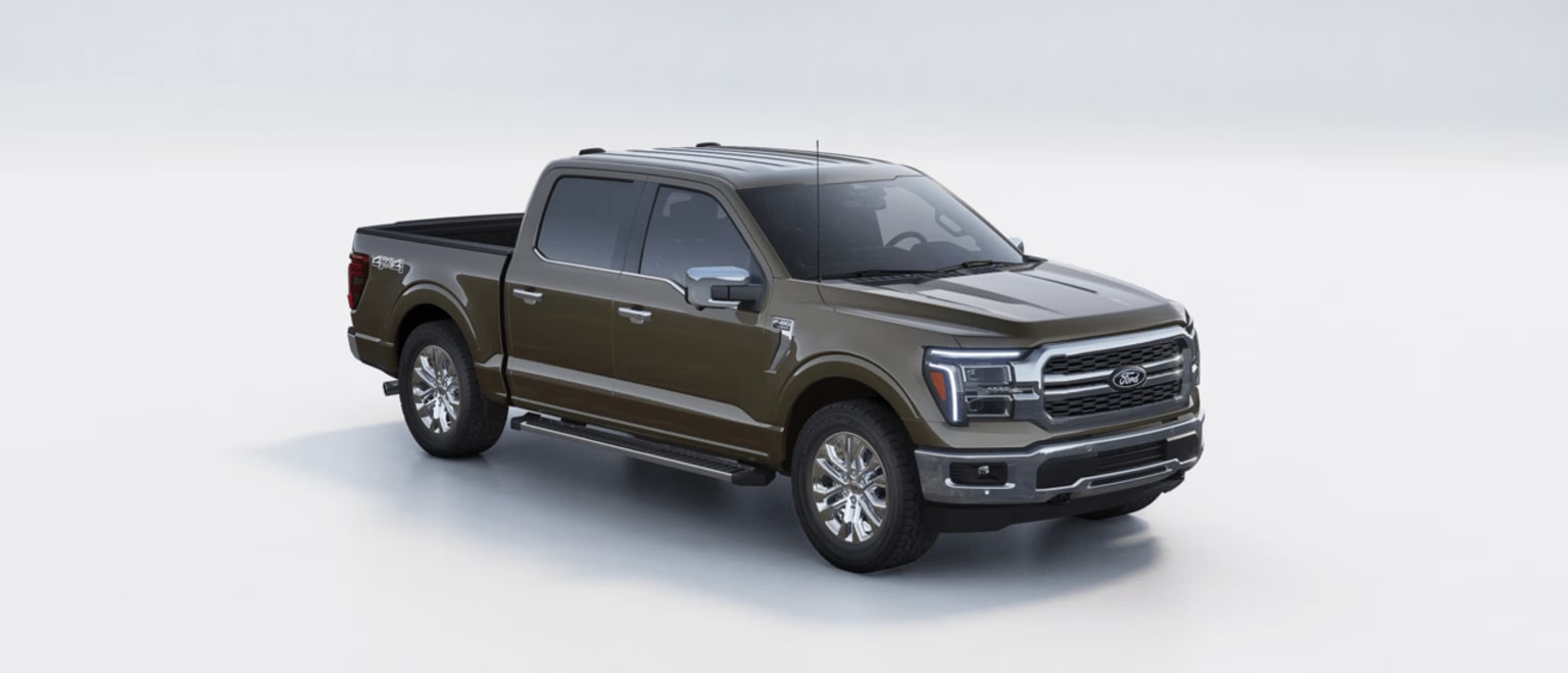 A large, rugged-looking pickup truck in a dark olive green color, set against a plain background.