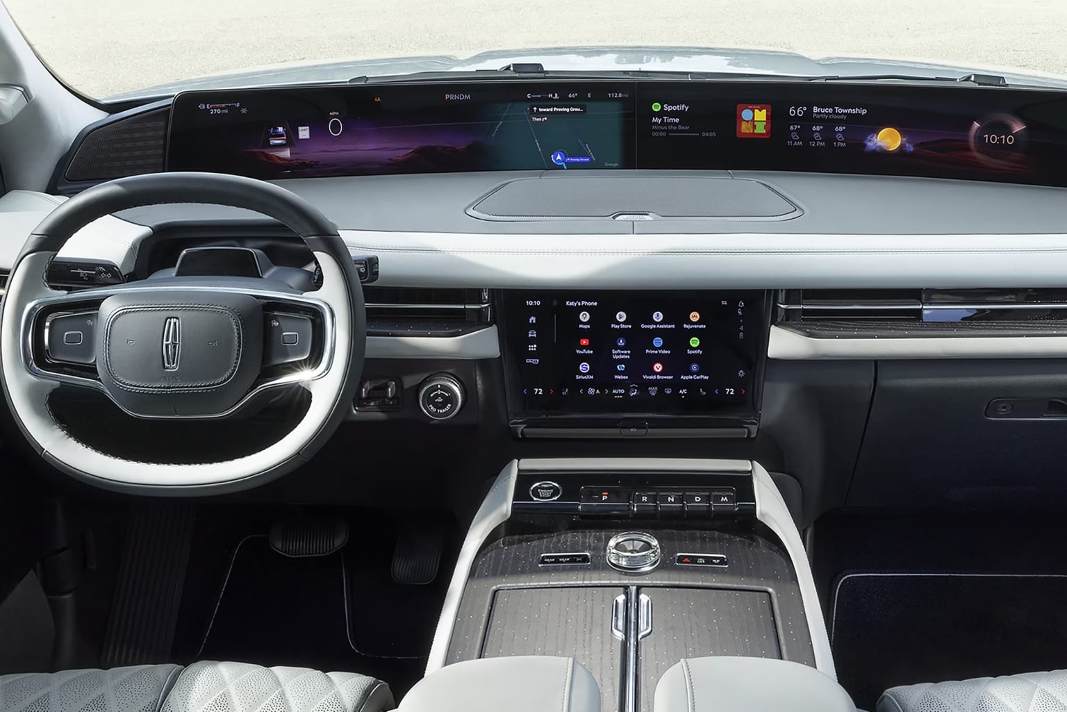 This appears to be the interior of a modern, high-tech vehicle, featuring a sleek dashboard with a large digital display, a steering wheel, and various controls and buttons. The overall design suggests a sophisticated and technologically advanced driving experience.
