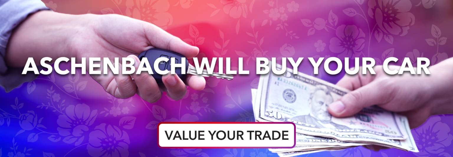 The image shows a hand holding cash bills against a colorful floral background, with the text "Dealer will buy and value your trade" prominently displayed.