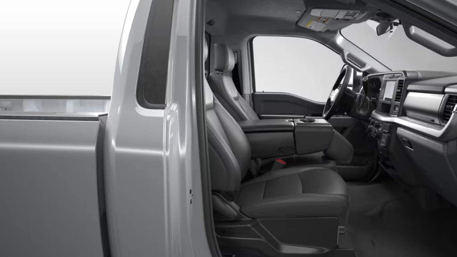 The image shows the interior of a vehicle, with the driver's seat and dashboard visible. The background appears to be a plain, light-colored surface.