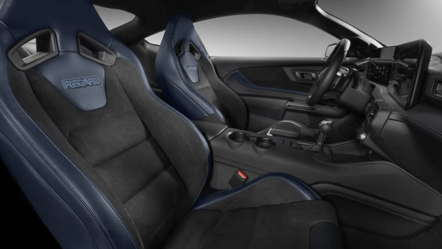 Interior of a high-performance sports car with racing-style seats and a sleek, modern dashboard design.