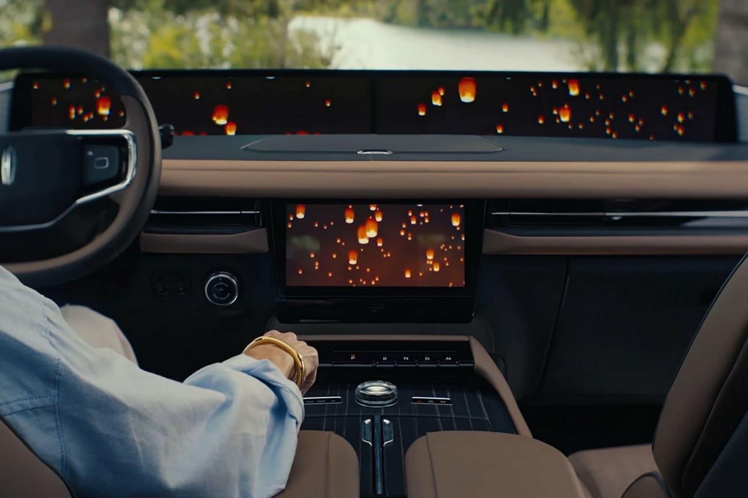 Interior of a vehicle with a fiery, abstract pattern displayed on the dashboard against a dark background.