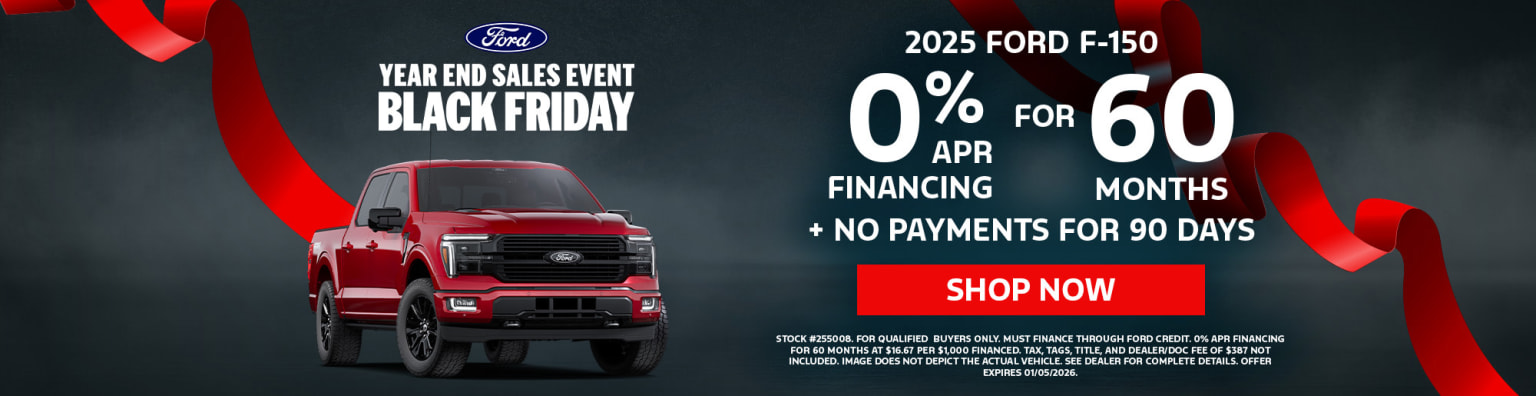 A red pickup truck is prominently featured in the foreground, with a Black Friday sales event advertisement in the background promoting financing options and delayed payments on a pickup truck.