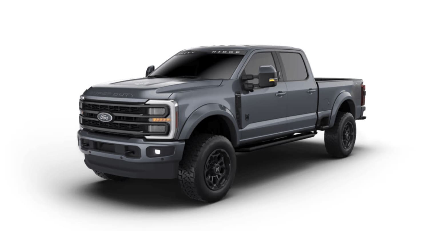 A large, rugged-looking gray pickup truck with off-road features and accessories, standing on a plain background.